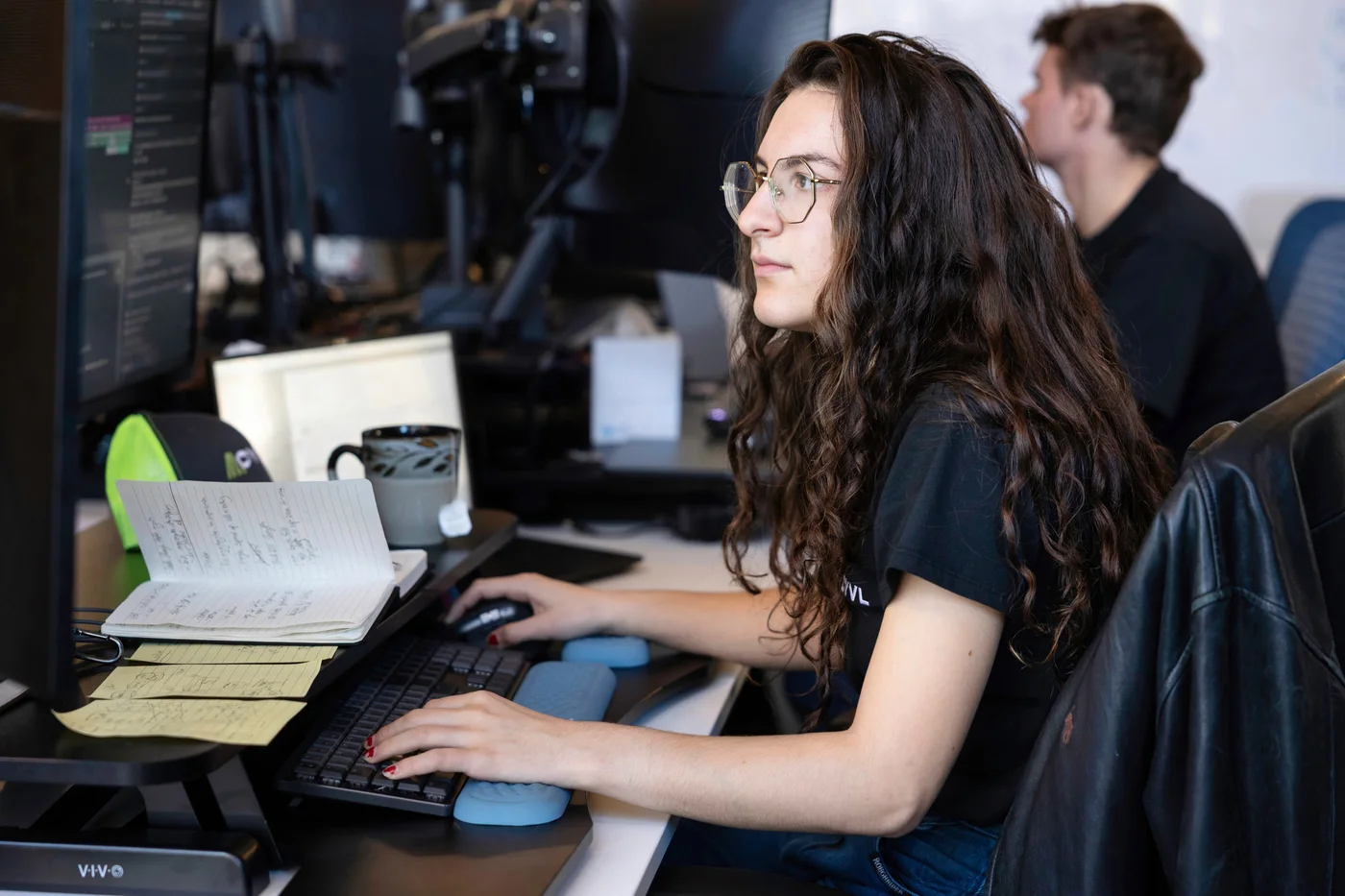 A CYVL engineer writing code at her desk